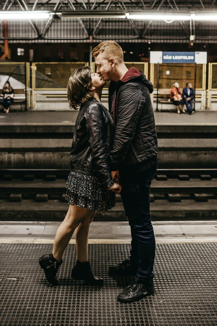 photo-of-couple-kissing-while-standing-on-train-station-3121473